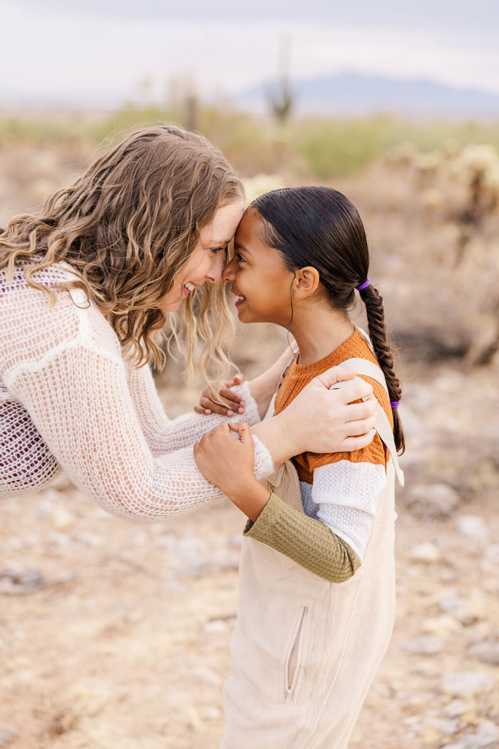 mother smiling and looking in her daughters eyes.