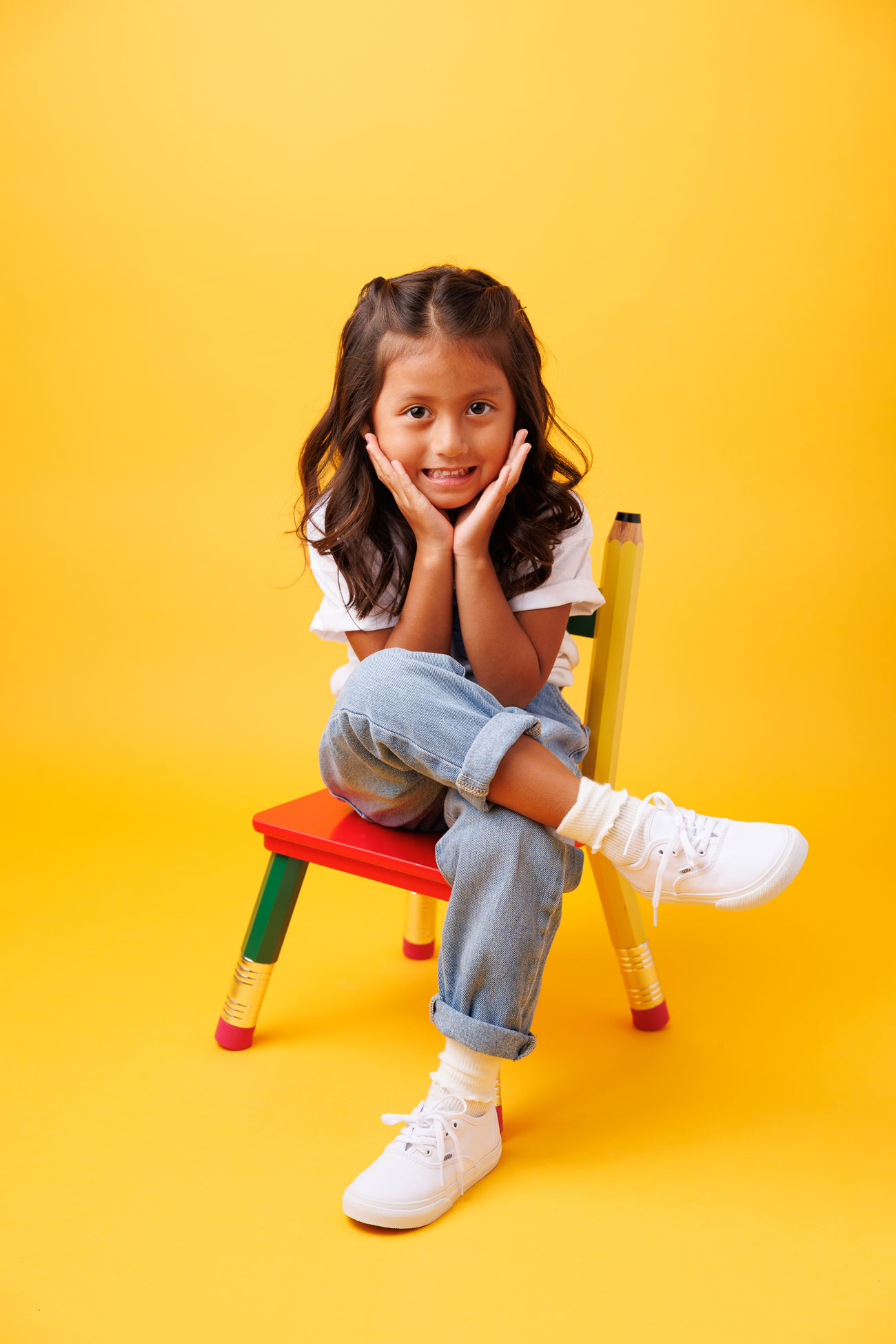 portrait of little girl seating of chair